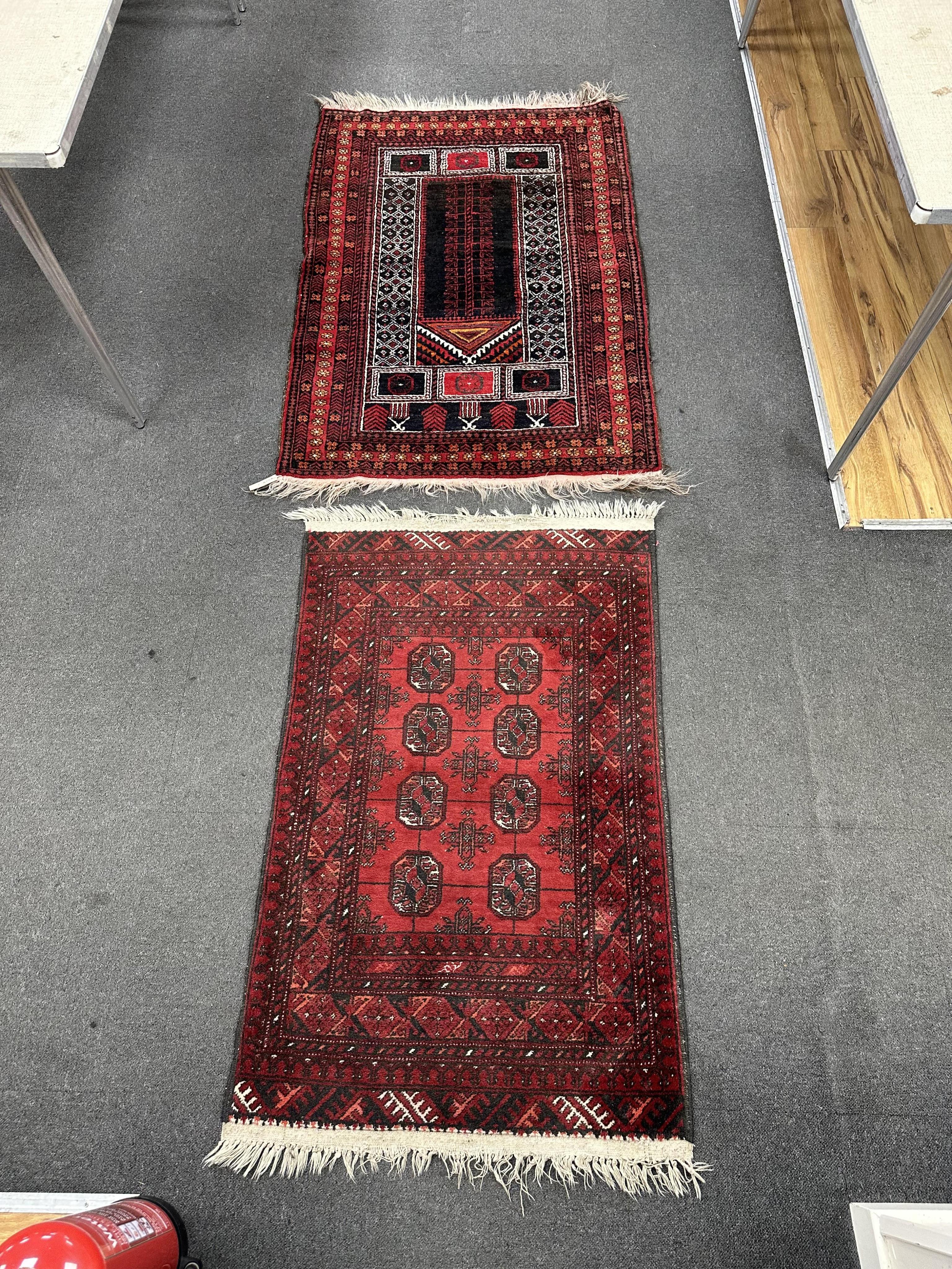 A Belouch prayer rug and Bokhara rug, larger 140cm x 95cm. Condition - fair.